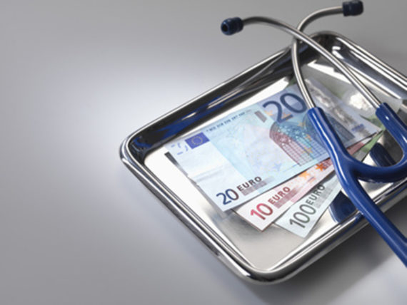 Stethoscope and euros on tray --- Image by © Andrew Brookes/Corbis